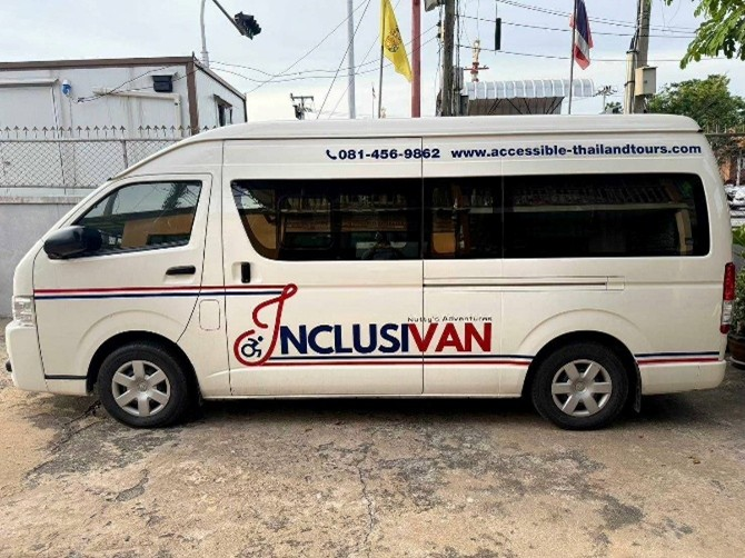 Inclusivan van with rear hydraulic lift platform assisting wheelchair user