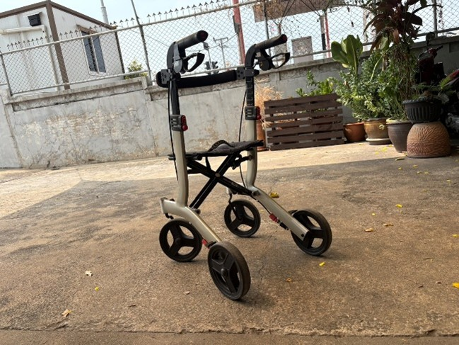 Walker rollator rear view showing hand brakes and seat