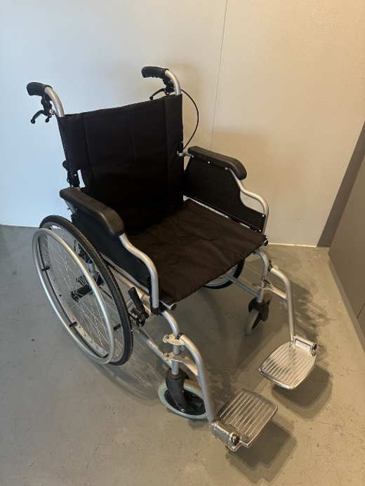 Wheelchair front view showing black padded seat